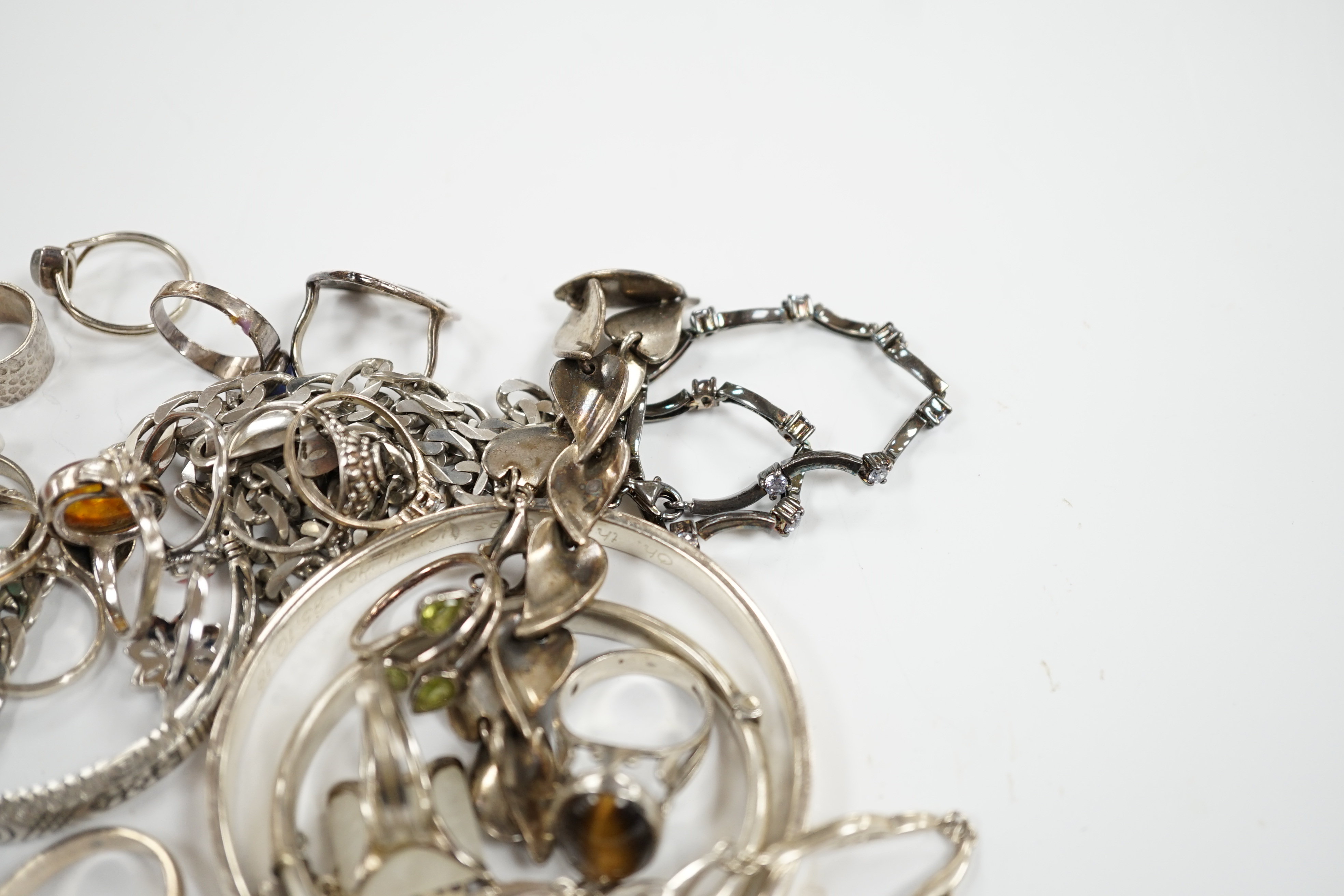 A collection of 925 and white metal rings, bangles and necklaces.